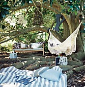 Garden corner for relaxing with bench, hammock and blanket