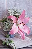 Arrangement of pink lilies and wild carrot