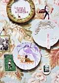 Old wall plates decorated with wrapping paper, fabric scraps, lettering and buttons