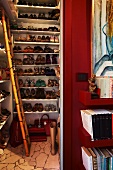 Ladies' shoes on floor-to-ceiling white shelving in niche