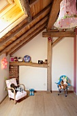 Child's bedroom in renovated attic with exposed wooden roof structure