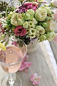 Festive bouquet and refreshing drink on table
