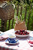 Garden table set with coffee and fresh cherries