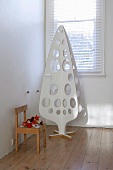 White plywood Christmas tree with round holes
