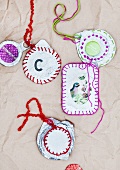Decorated foil pot lids used as picture frames and pendants