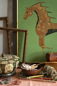 Table with Ceramic Dish, Tray with a Bowl with Twine and and Pencils; Mosaic Horse in Background