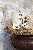 Decorative straw nest with birds' eggs in amphora