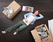 Woman laying on floor with boxes