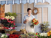 Florist with bouquet in shop