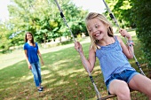 Girl on swing in garden