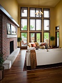 Yellow living room with two white couches and fireplace