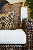 Woven armchair with throw pillows