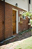 Brick wall and wooden door to apartment home