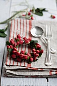 Small wreath of hypericum berries on linen napkin