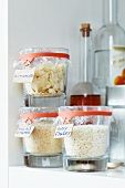 Kitchen supplies in jars sealed with cling film and preserving jar rubber bands