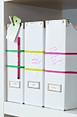 Box files labelled with rubber bands