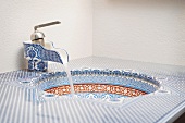 Blue and red geometric patterned bathroom sink
