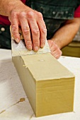 Smoothing a block of soap