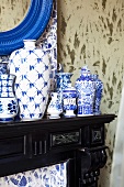Various blue and white china vases on black mantelpiece