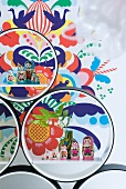 Russian dolls in circular shelving units in front of colourful wall sticker
