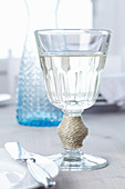 Wine glass decorated with cord wrapped around stem