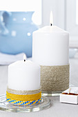 Pillar candles decorated with twine and cord