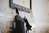 Bag and coathanger hanging on wall hooks