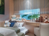 Collection of soft toys on windowsill in light, modern bedroom