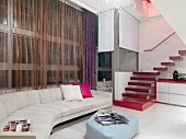 Sofa combination with upholstered ottoman and staircase with red floating treads in contemporary interior