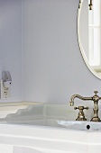 Elegant Bathroom with Vintage Faucet and Oval Mirror