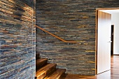 Hardwood Staircase with Stone Tile Walls