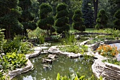 Pond and topiary trees in gardens