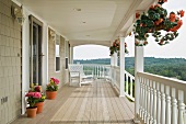 Large front porch of shingle style home with great view of tree tops
