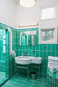 Bathroom with turquoise tiles on floor and walls