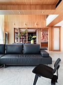 Modern living room with black leather sofa