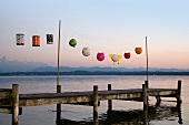 Paper lanterns strung up on wooden pier
