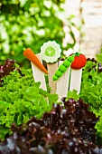 Decorative plant labels with plastic vegetables
