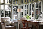 Bright workspace with traditional country-house furniture in bay of latticed windows