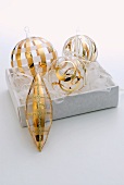 Set of glass Christmas baubles with delicate gold stripes in white box