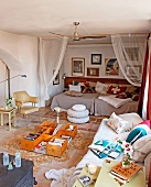 Comfortable couch with cushions and improvised, low coffee table in front of relaxation area in niche in Mediterranean living room
