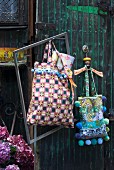 Shopping bags in various patterns decorated with colourful pompoms