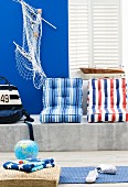 Interior with maritime decor, marble bench & striped seat cushions