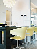 Modern mood - light colored swivel shell chairs by a table made of dark wood