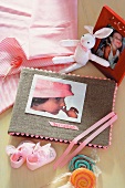 Photo album with hand-crafted cover amongst toys and sweets