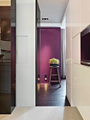 Blick auf Blumenständer vor lila getönter Wand in modernem Wohnraum