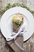 A place setting with a rose and gypsophila