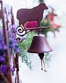 Vintage, metal 'dinner bell' decorated with a sheep on a garden gate