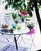 Hurricane candles and lemons on a patio table with folding chairs