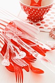 Red and transparent plastic cutlery for a child's birthday party