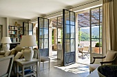 Grosszügiges Wohnzimmer mit geöffneten Terrassentüren in einem provenzalischen Landhaus
